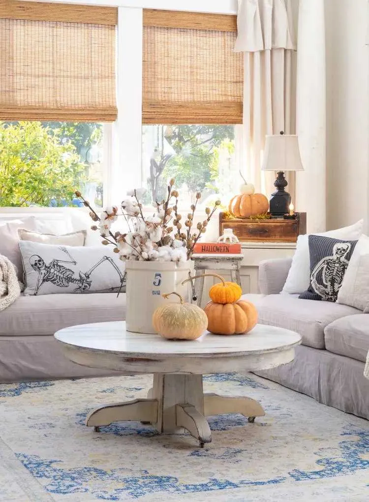 autumn decoration 2023 with decorative cushions and pieces on the couchtable in living room