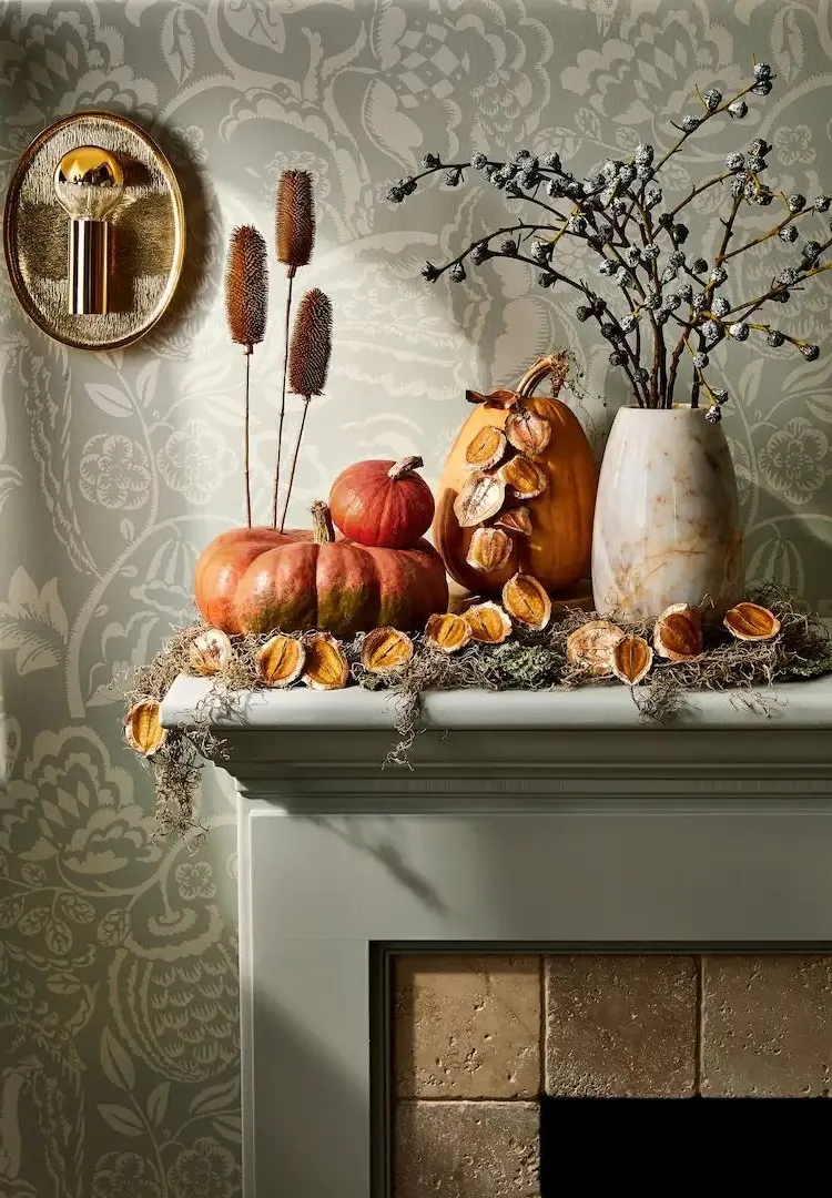 autumn decoration for fireplace sims with dry flowers in vase and potpourines in matching colours