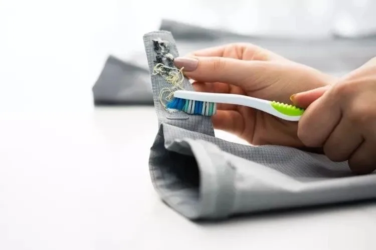 cleaning velcro fasteners with toothbrush