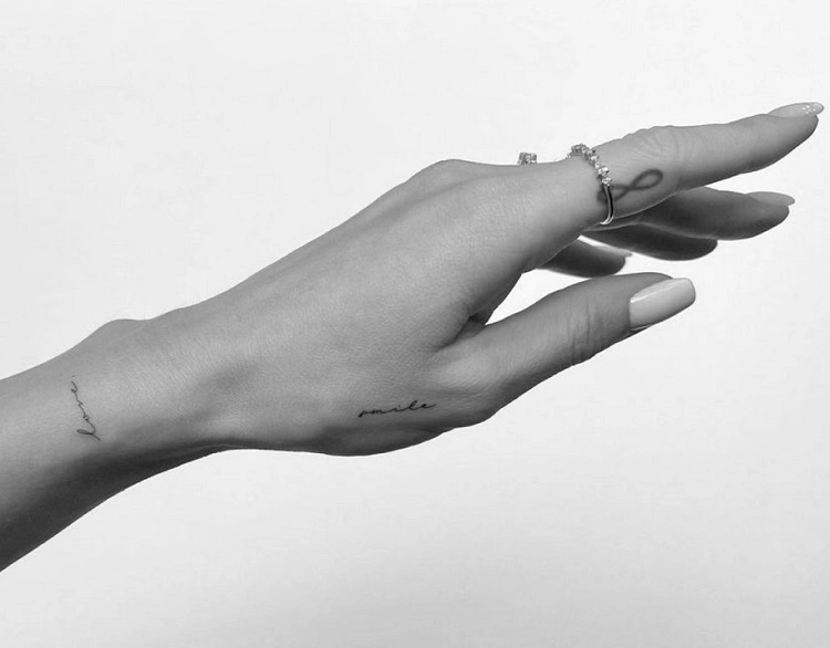 discreet cursive word tattoo on hands for women 2023