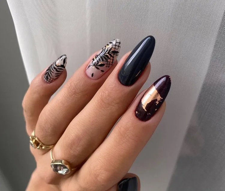 fall black nails with golden decoration almond shaped