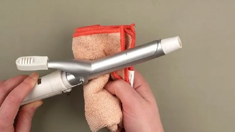 how to clean a curling iron wipe with a wet towel