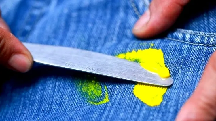 how to remove paint from jeans scrub with a blint knife