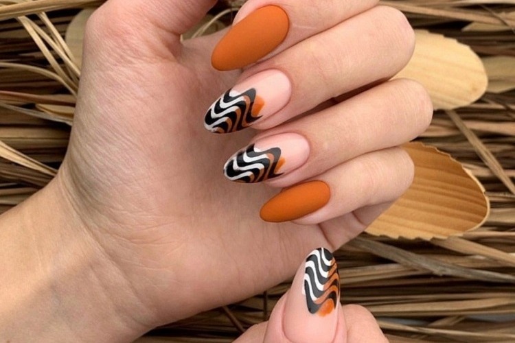 matte burnt orange fall nails abstract wavy french tips design 2023