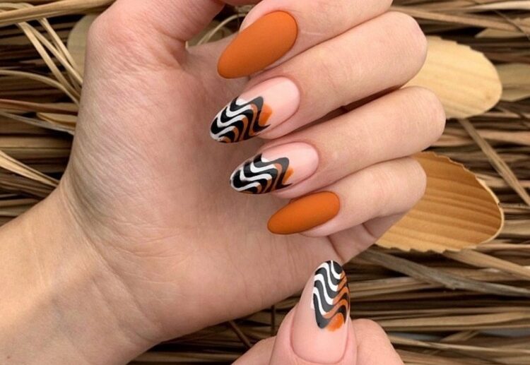 matte burnt orange fall nails abstract wavy french tips design 2023