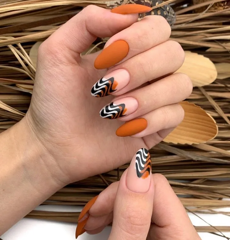 matte burnt orange fall nails abstract wavy french tips design 2023