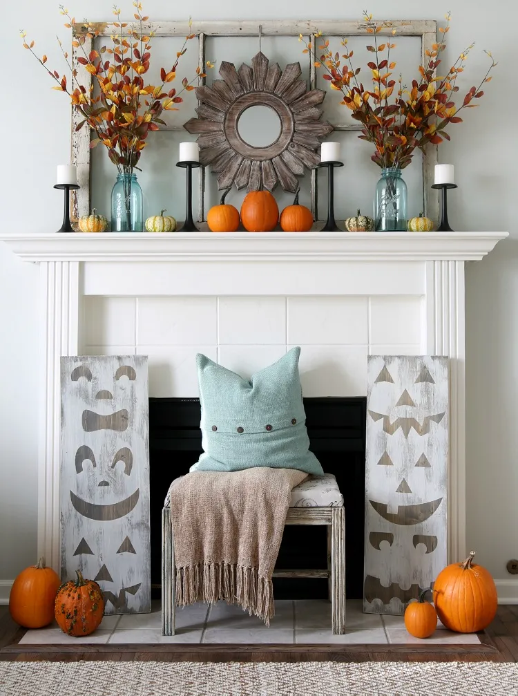 modern symmetrical fall halloween fireplace mantel decor idea faux leaves bouquet pumpkin display candles