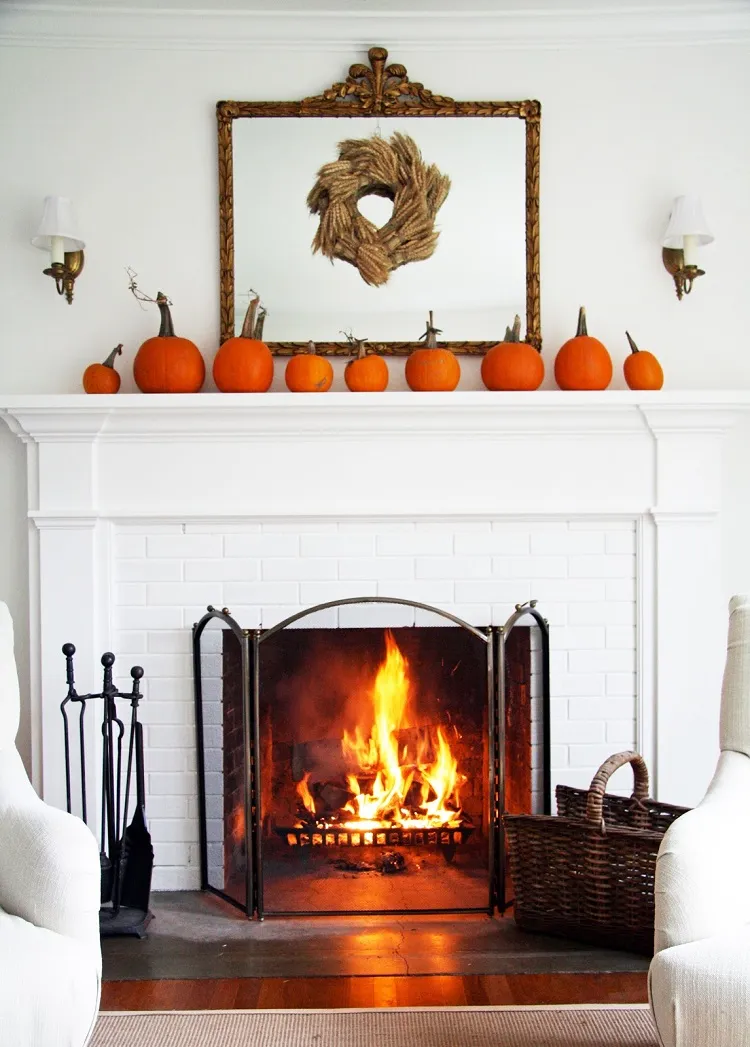 pumpkin display wheat wreath simple minimalist elegant halloween decor fireplace mantel