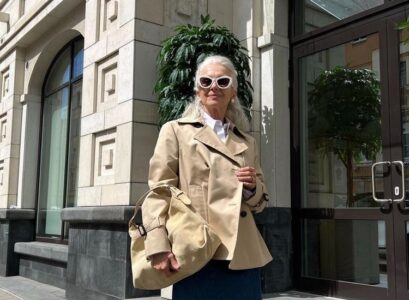 short trench coat and denim skirt fall fashion for a 70 year old woman
