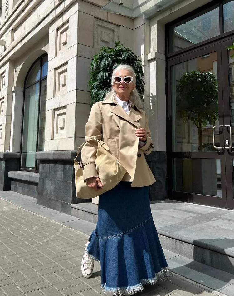 short trench coat and denim skirt fall fashion for a 70 year old woman