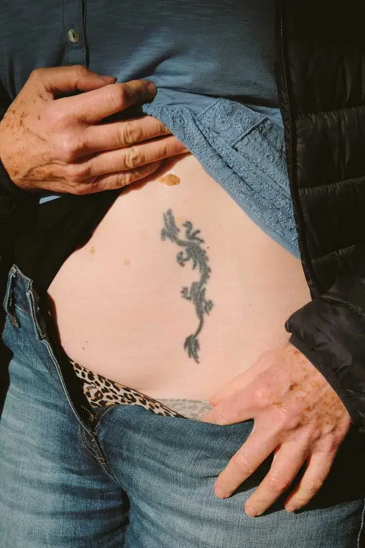 stomach arm tattoo for 50 year old woman