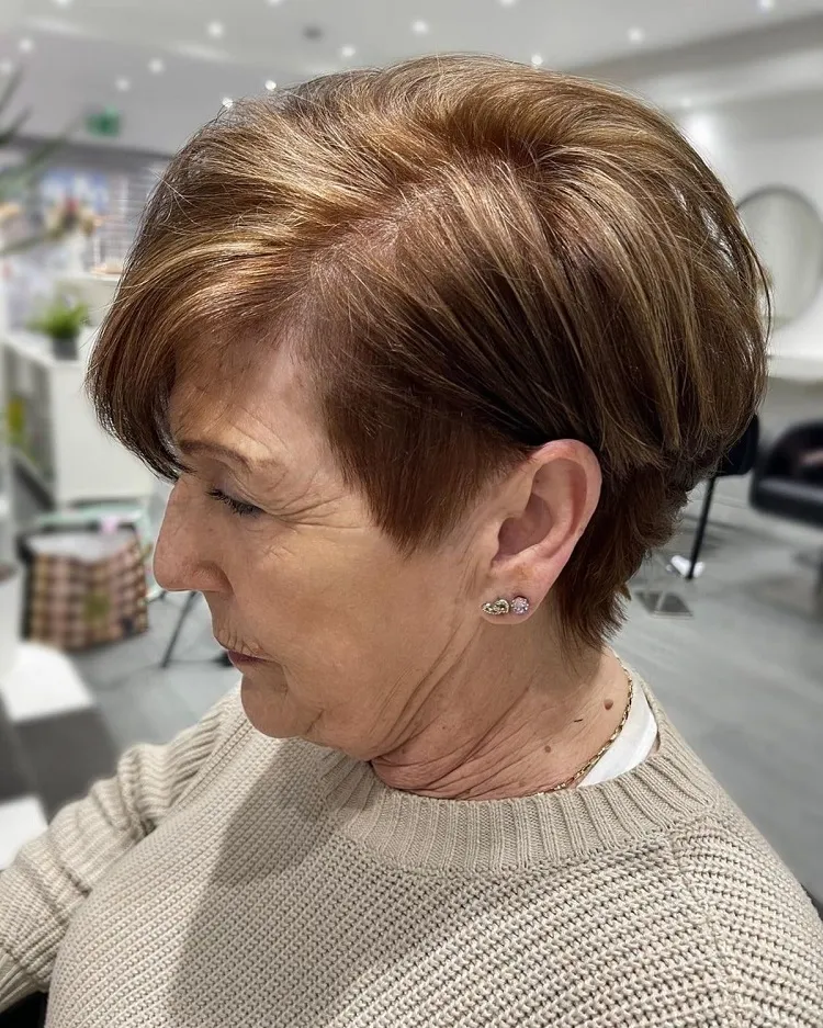 tousled pixie bob with a shaved side haircut for older women