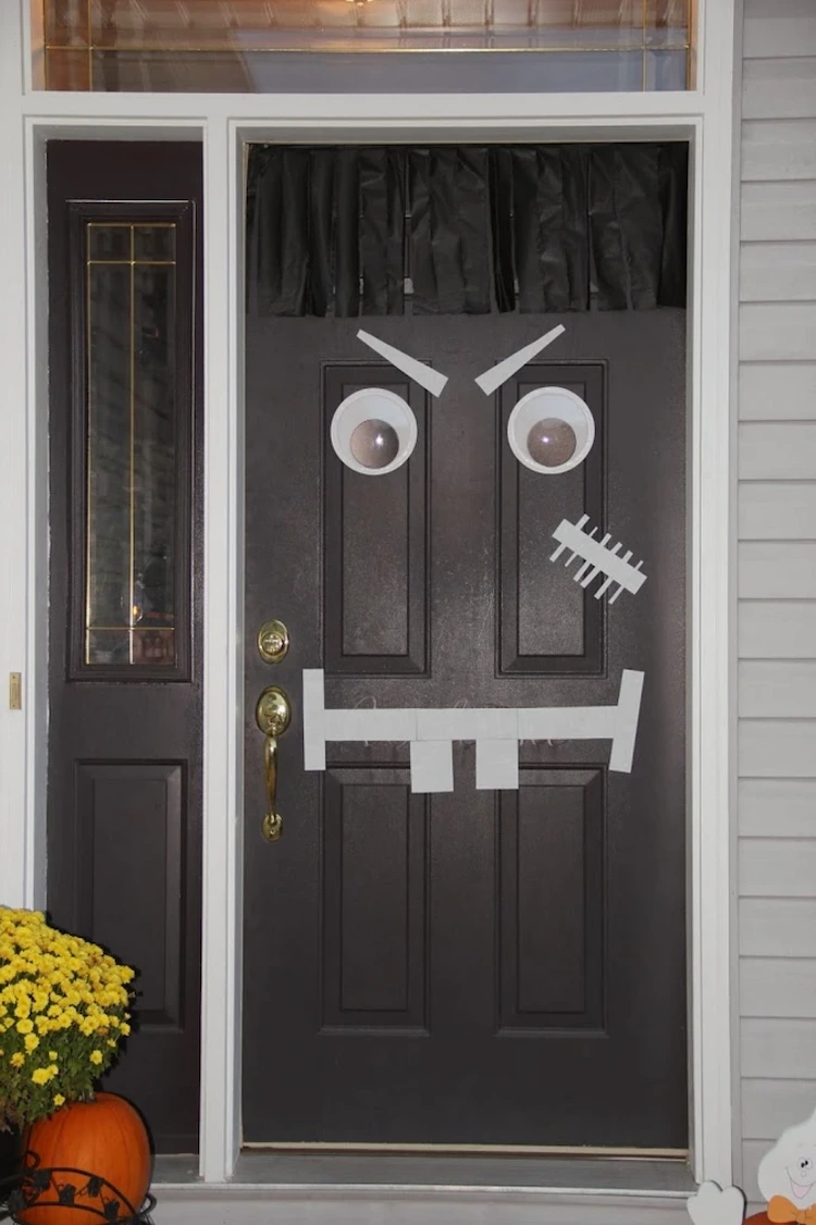 make a scary face for the front door from painters tape and googly eyes