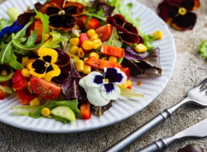 violet flower salad with cucumber corn tomatoes and peppers