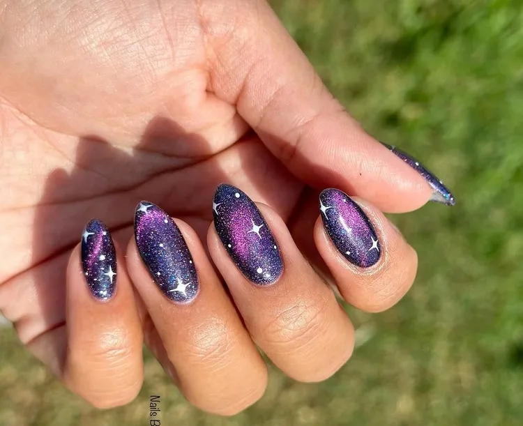cat eye nail effect design manicure purple with star decoration galaxy
