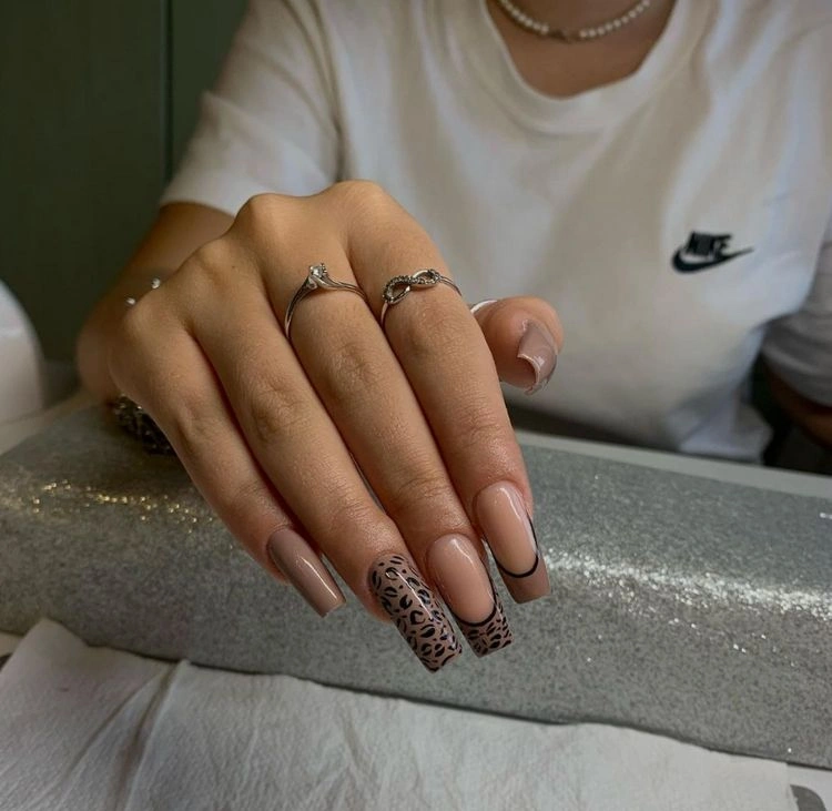 cheeky brown nail design with animal pattern