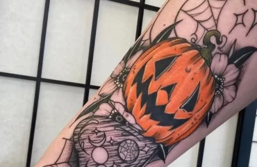 forearm halloween tattoo with a pumpkin 2023