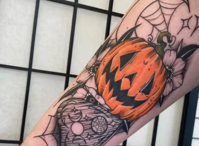 forearm halloween tattoo with a pumpkin 2023