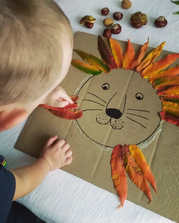 glueing fall leaves cardboard lion cub diy art project kids