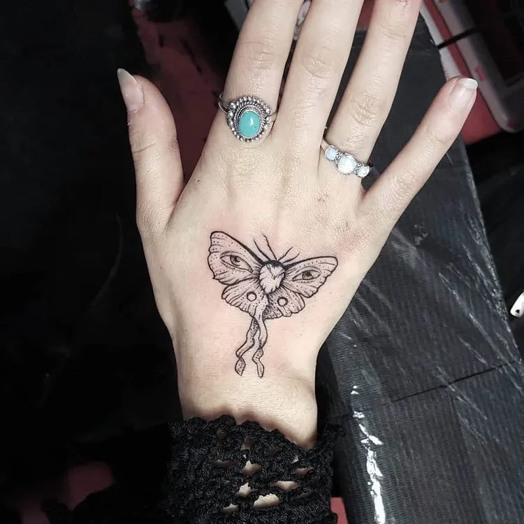 hand moth tattoo