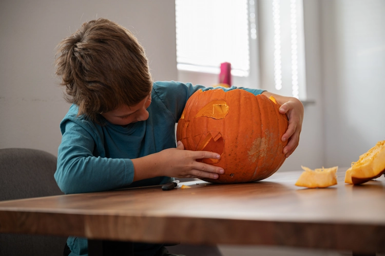kid carving halloween pumpkin classic jack o lantern