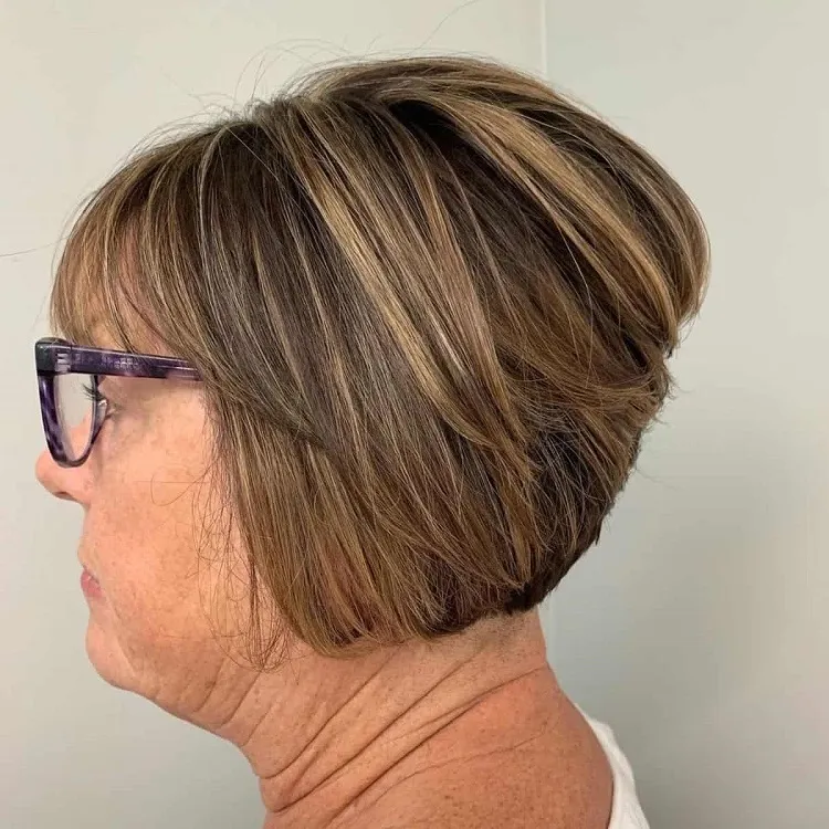 layered bob with highlights for older women with large glasses frames