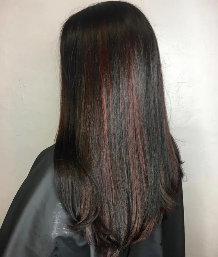minimalistic red peekaboo highlights on brown hair
