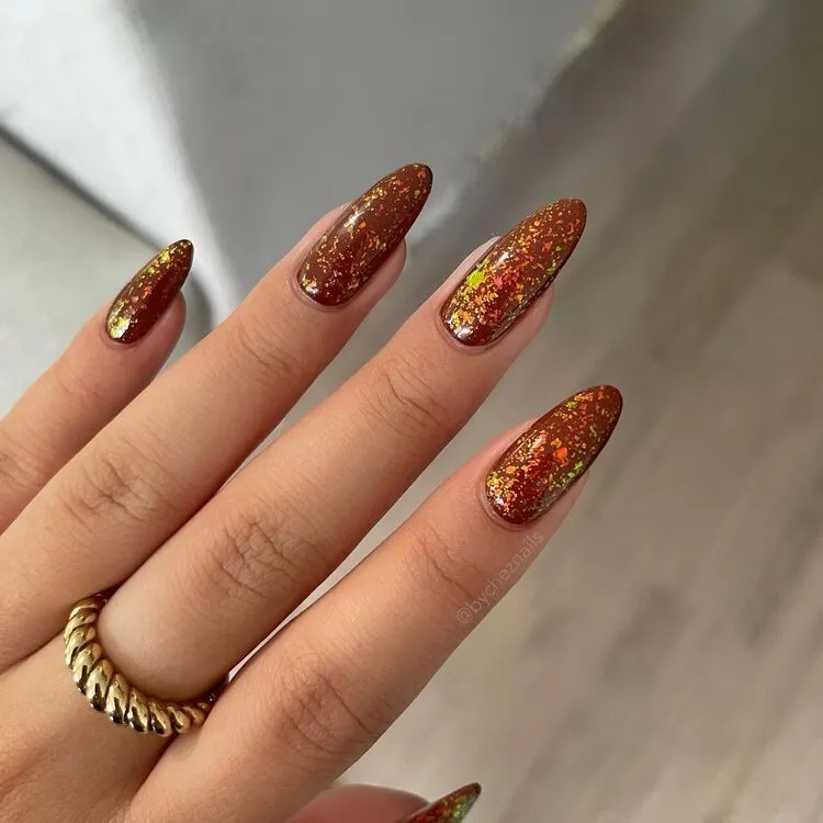 pumpkin spice nails with glitter flakes
