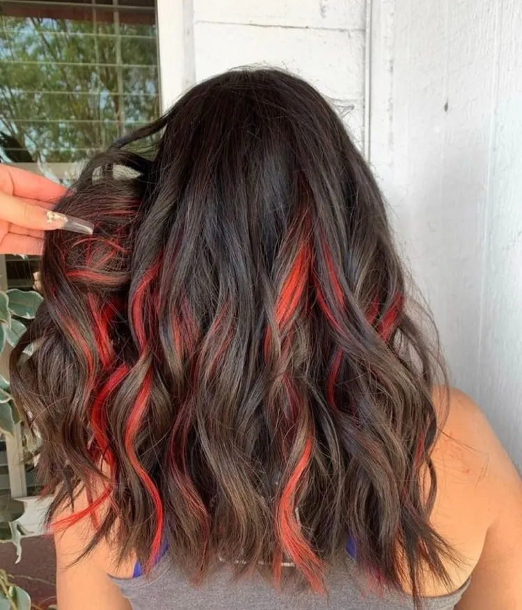 red peekaboo highlights dark brown curly hair hairstyle ideas 2023