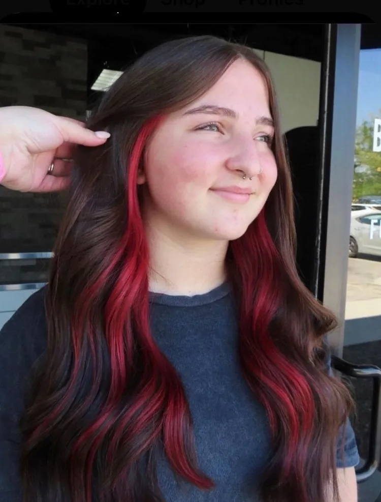 red peekaboo highlights on long brown hair