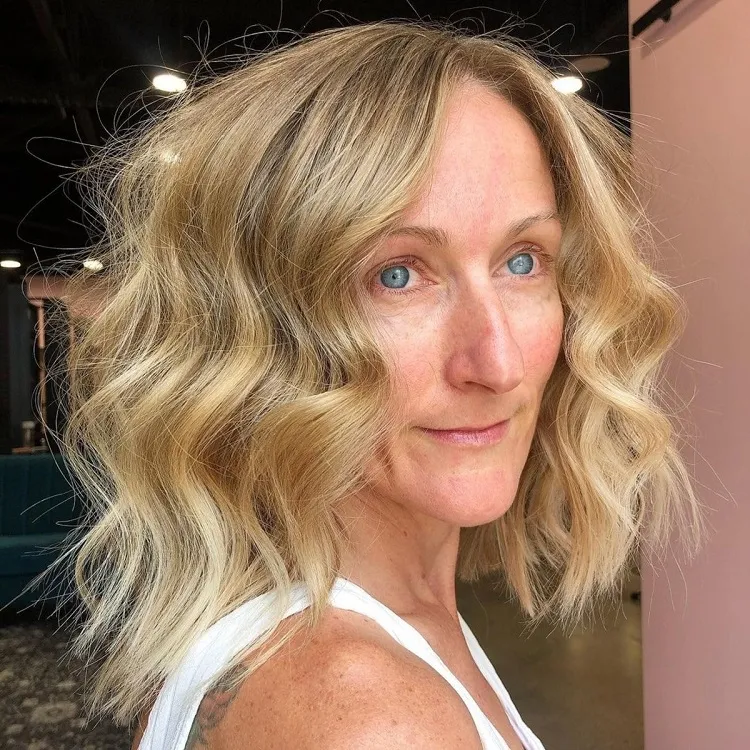 rejuvenating medium length wavy lob hairstyle for 50 year old women