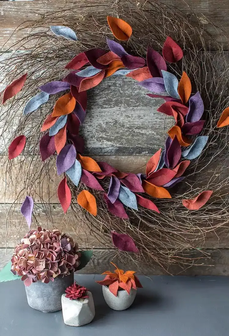 rustic romantic wall wreath for autumn with branches and felt