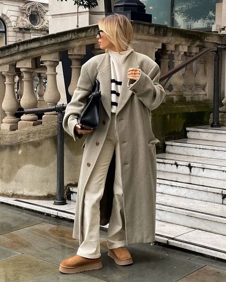 styling ugg tazz suede platform slippers to work straight white jeans oversized long taupe coat old money striped sweater big leather handbag