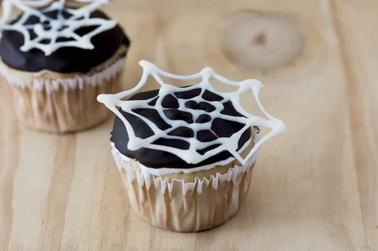 white chocolate spider web cupcake decoration