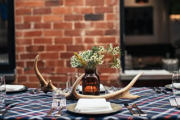 antlers and fresh flowers as a centerpiece