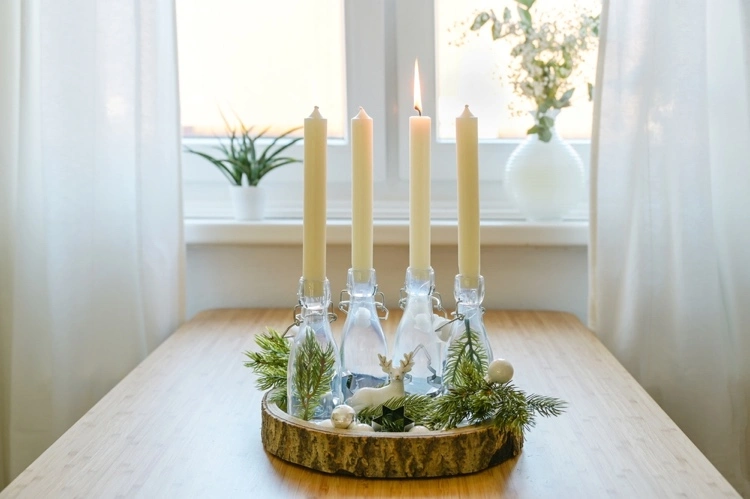 diy advent wreath with glass bottles on a wooden disc