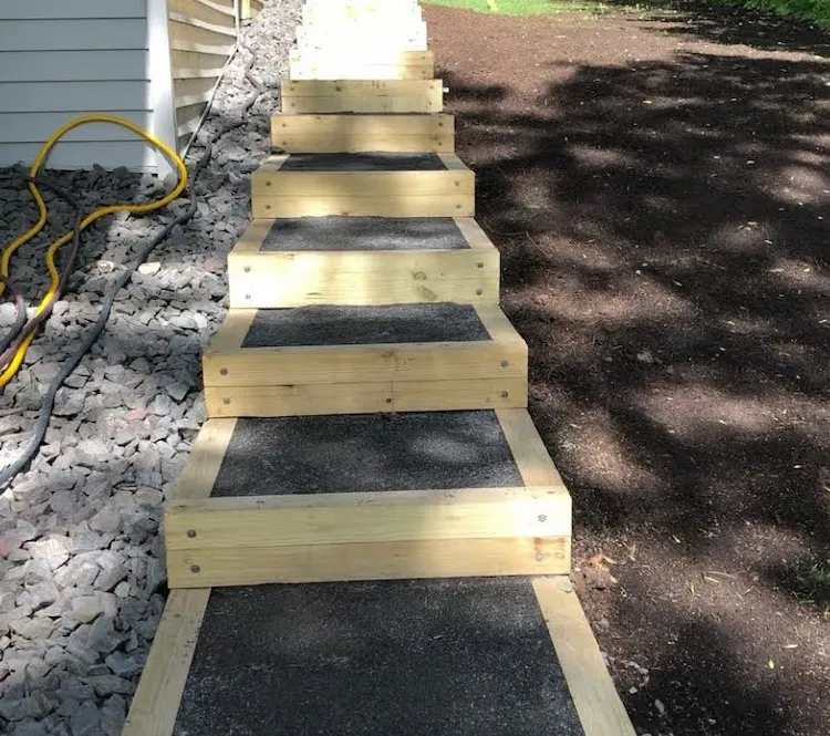 build a simple garden staircase yourself using wooden boards and soil for sloped garden