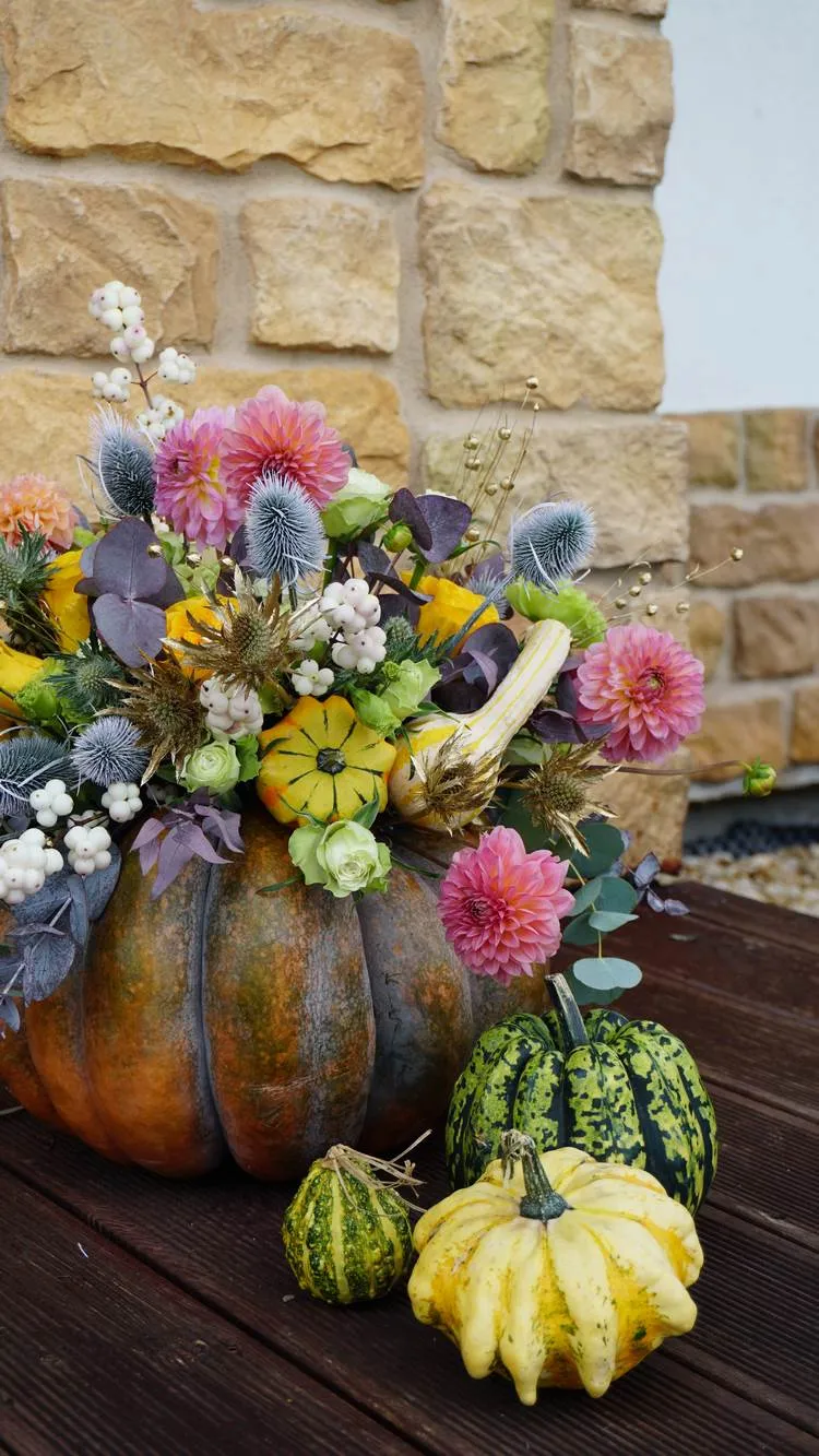 a diy pumpkin vase and flowers centerpiece