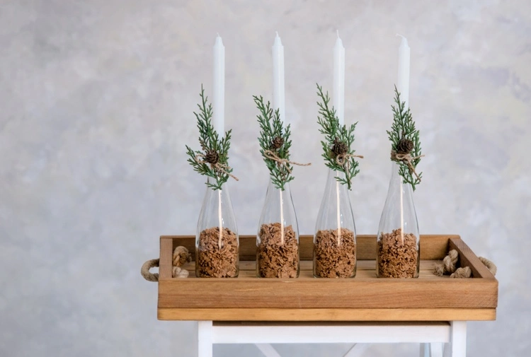 advent candles in bottles with natural decorations