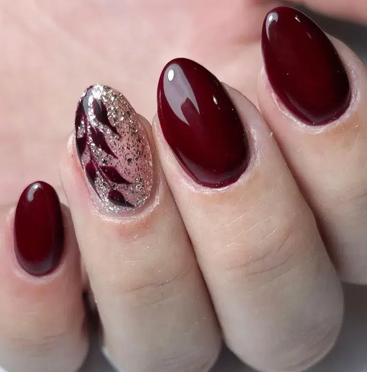 burgundy and gold nail art on short almond nails