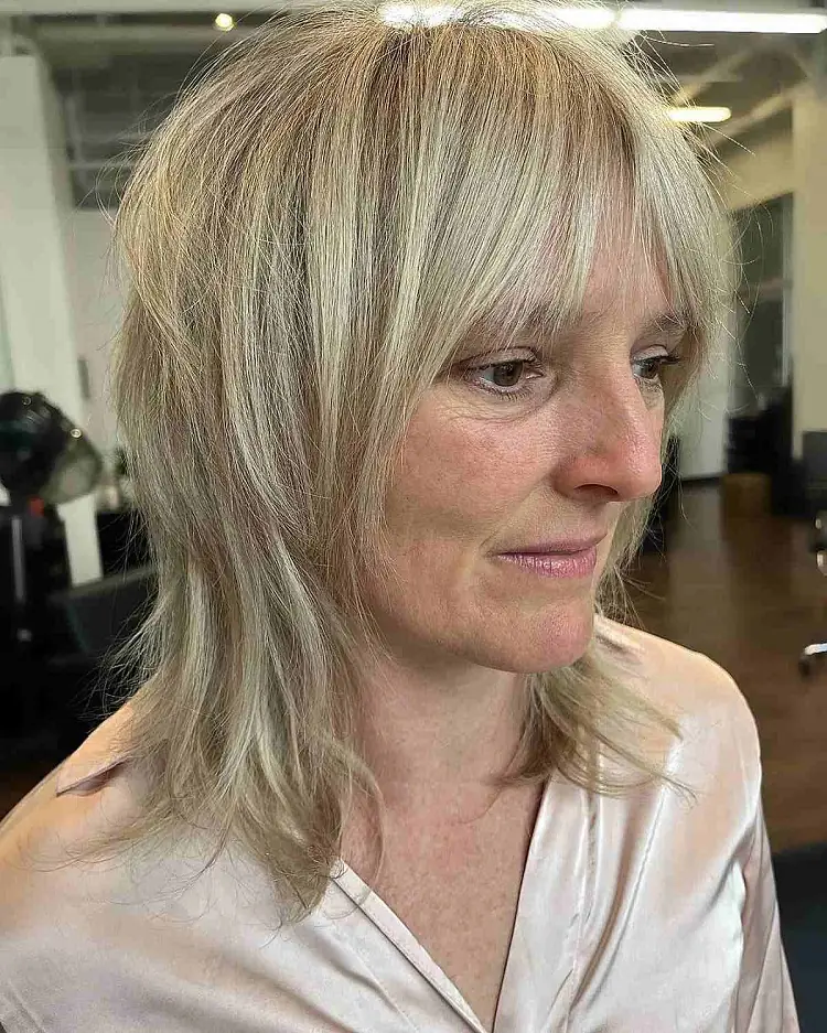 choppy bangs medium length tapered haircut woman over 60