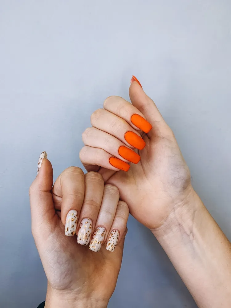 december nails 2023 bold matte orange nail polish gold flakes