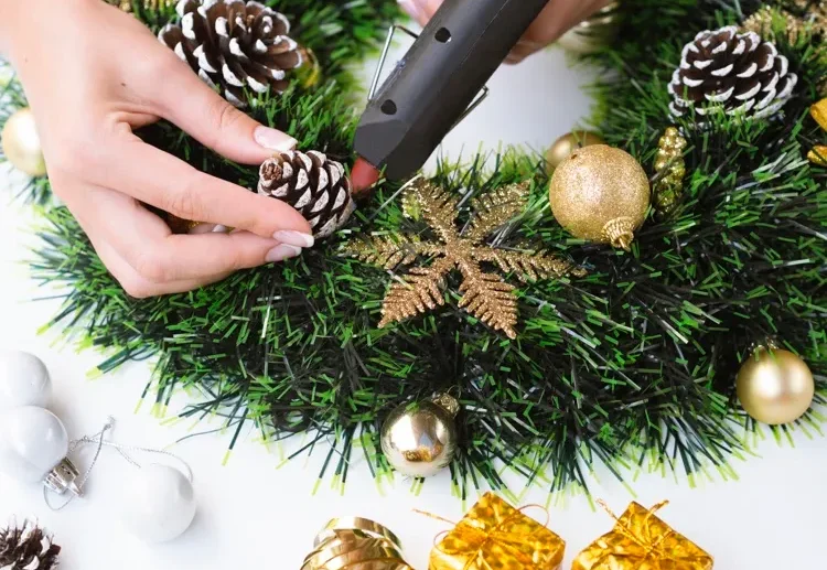decorate christmas wreath with snow covered pine cones