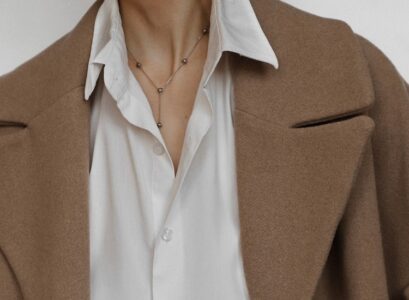 half tucked white shirt brown coat high waisted leather pants styling inspo winter 2023 2024