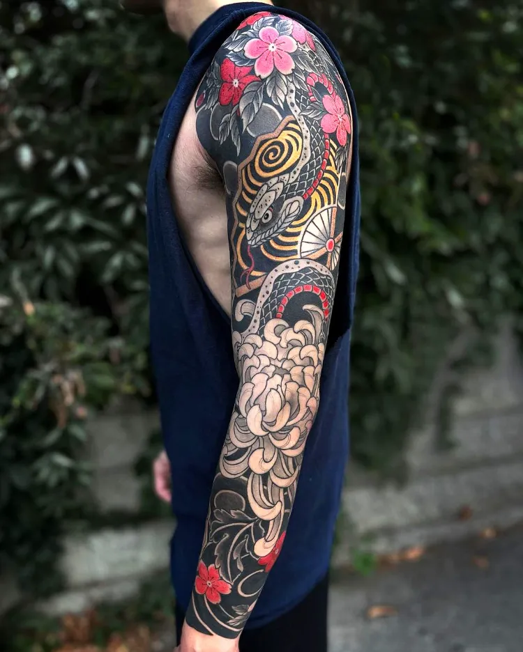 New school shoulder tattoo of a chrysanthemum.