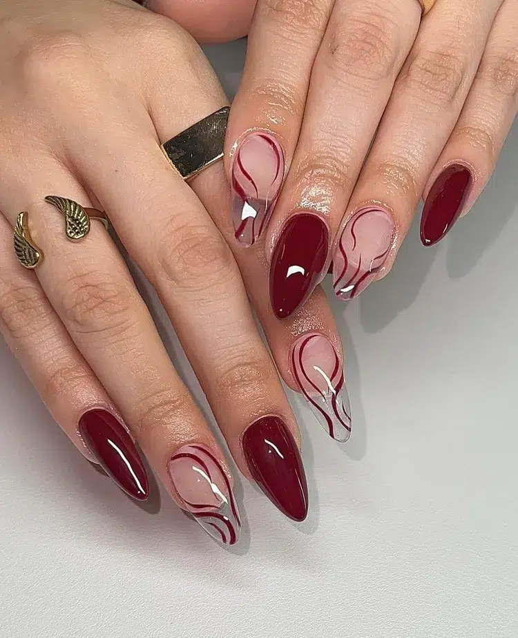 long stiletto nails burgundy red manicure with abstract effect