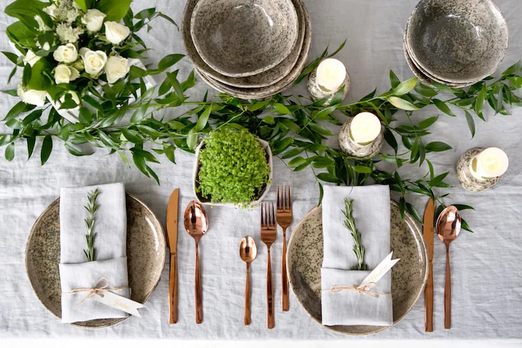 trendy minimalist christmas table setting greenery rustic tableware