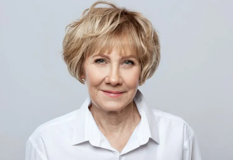 voluminous short bob straight choppy bangs woman over 60