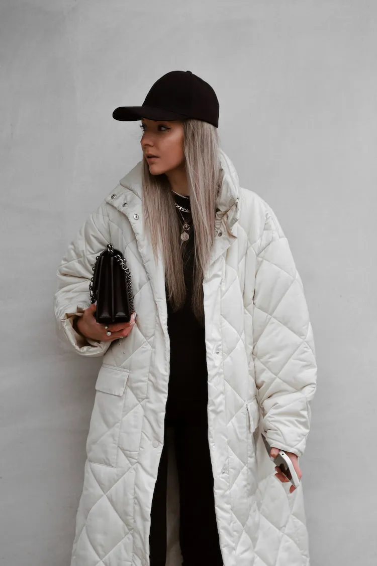 white puffer coat black baseball cap casual winter outfit 2023 2024