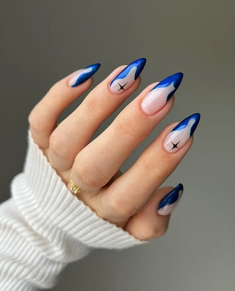 winter manicure 2024 abstract nail art in blue almond nails